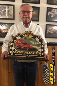 Man holds racing trophy triumphantly