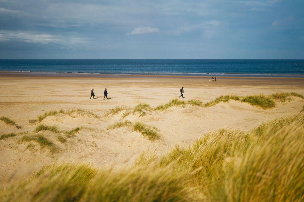 People walking on sunny beach