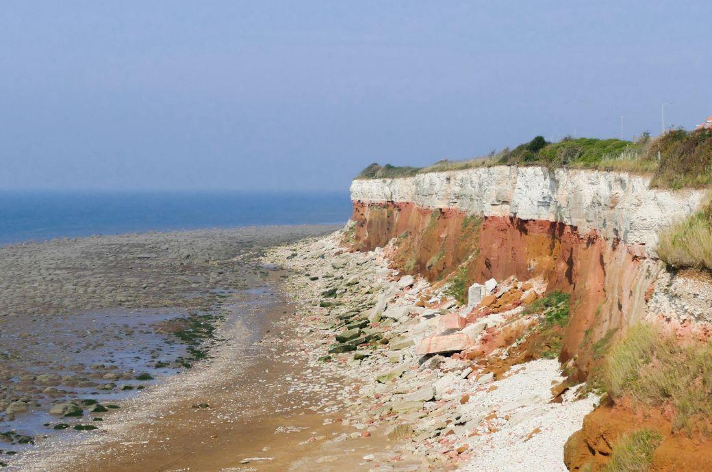 Rocky coastal cliff with green grass