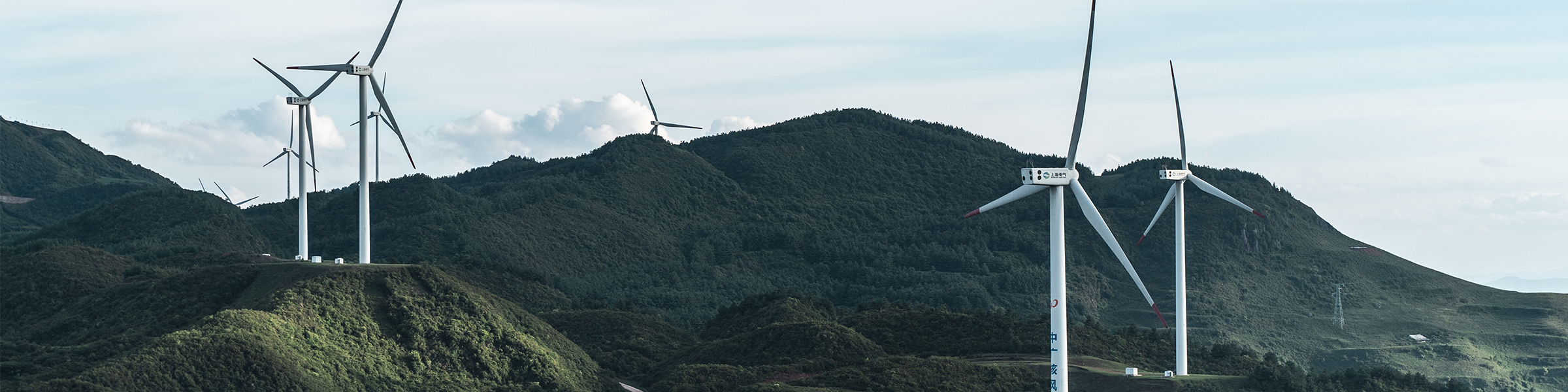 Wind turbine against mountainous backdrop