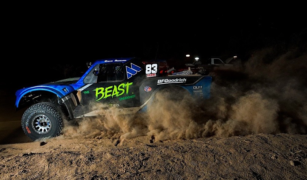 Off-road truck racing through dirt track