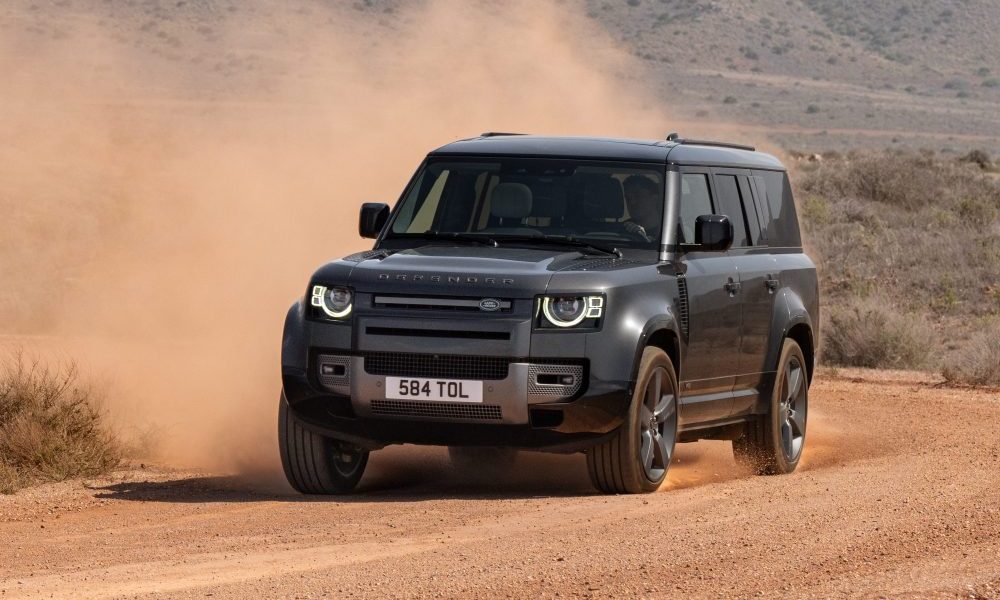 Dark gray Land Rover Defender driving