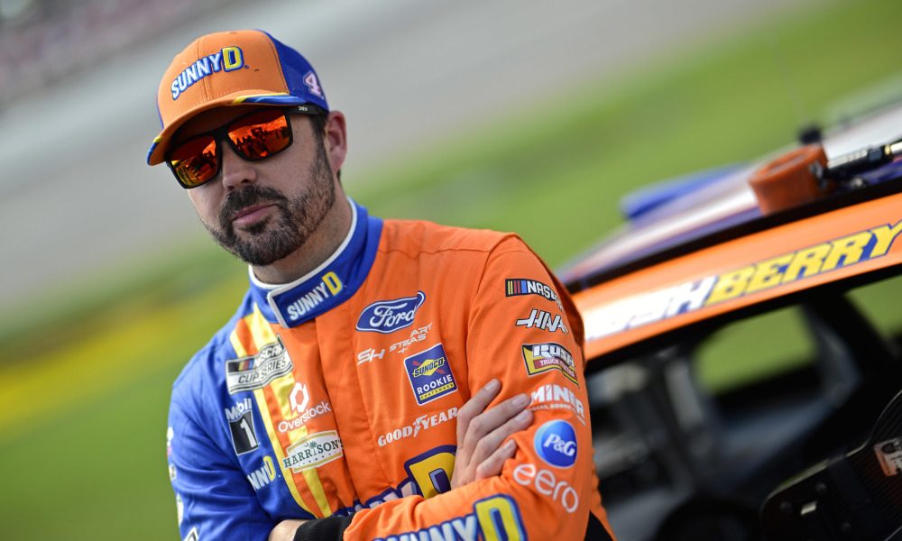 NASCAR driver beside racing car