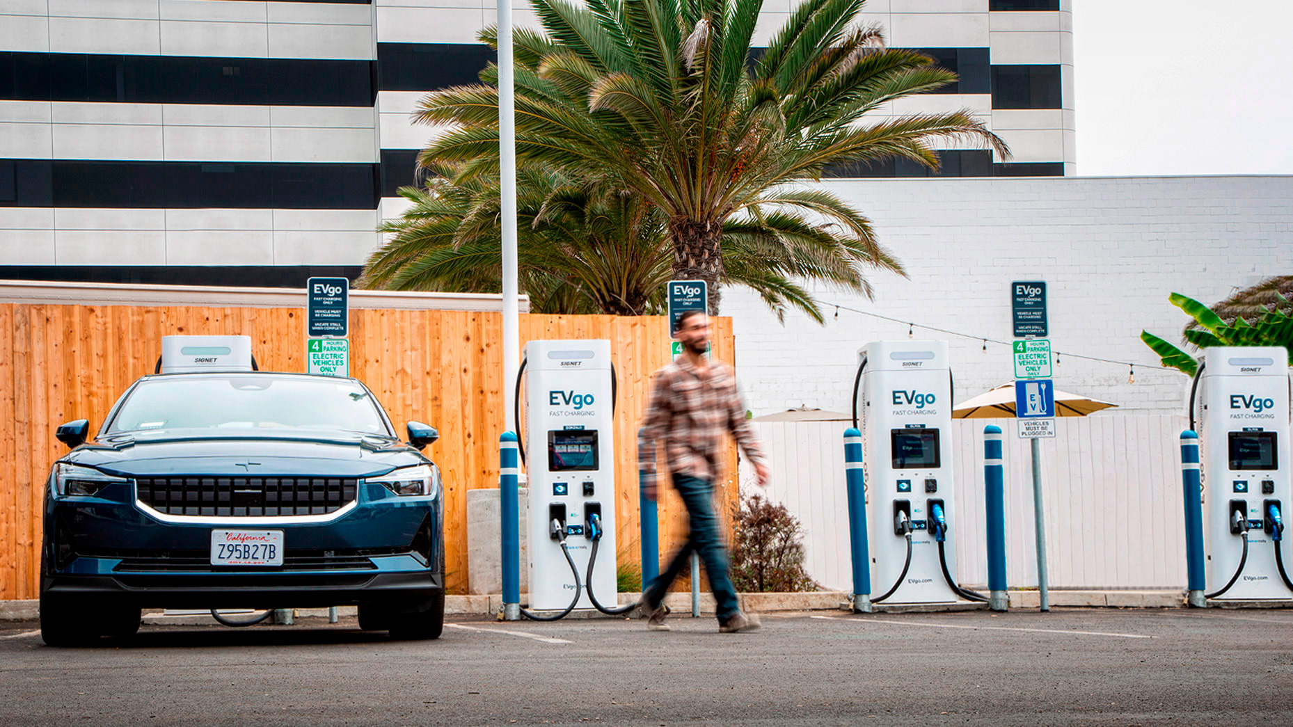 Man passing EVgo charging stations