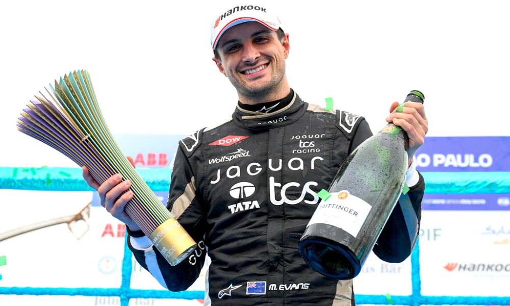 Racing champion celebrates with trophy