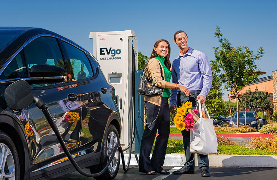 Happy couple at EV charger