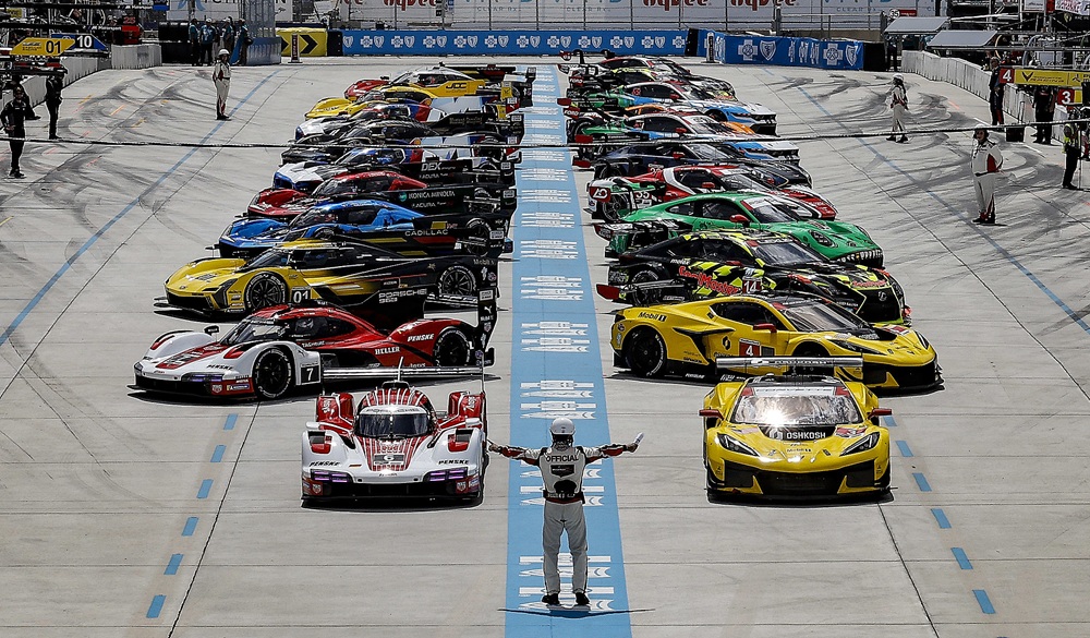 Race driver poses at track