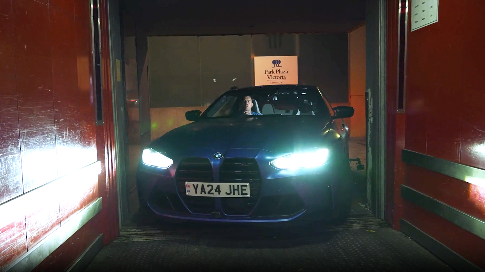 BMW M4 driving into elevator