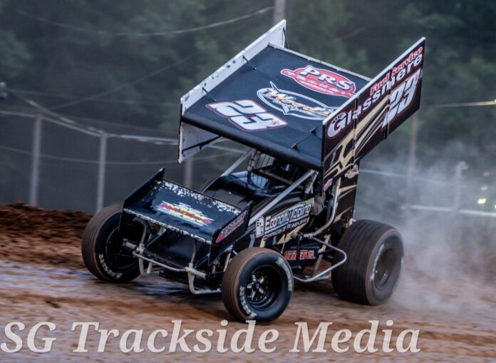 Black sprint car racing on dirt