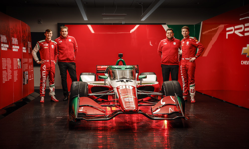 Four men beside Prema F1 car