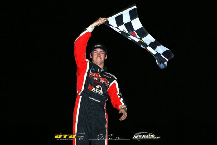 Driver celebrates win with checkered flag