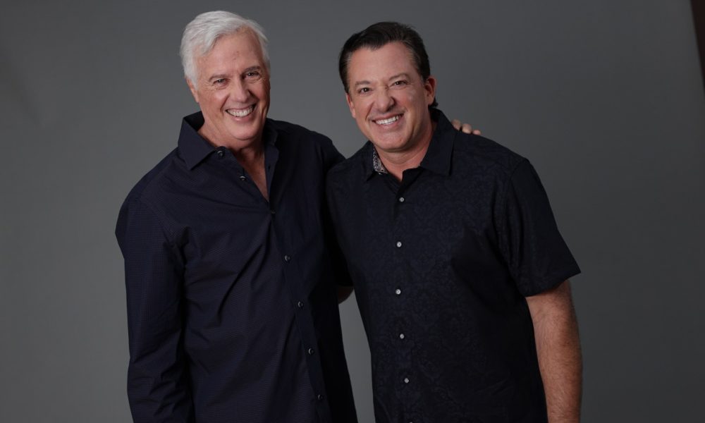 Two racing drivers in studio portrait