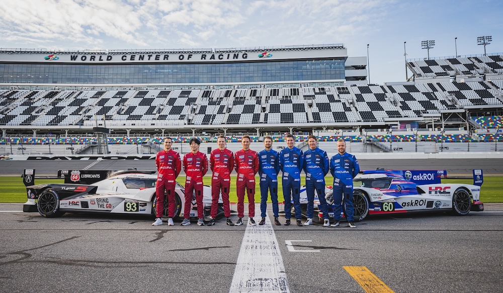 Race car drivers with vehicles trackside