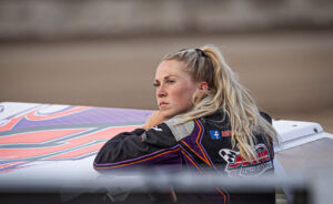 Woman posing with dirt track car