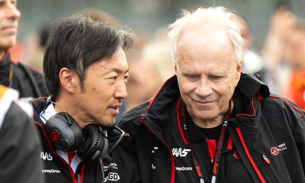 Two racers in black racing suits