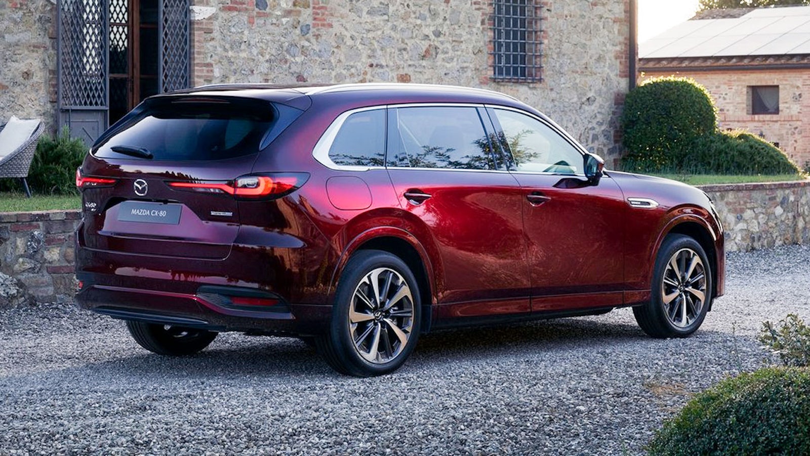 Mazda CX-80 by stone building