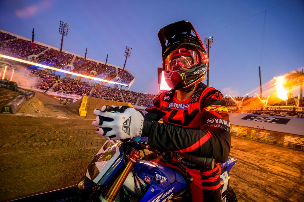 Motocross racer on blue dirt bike