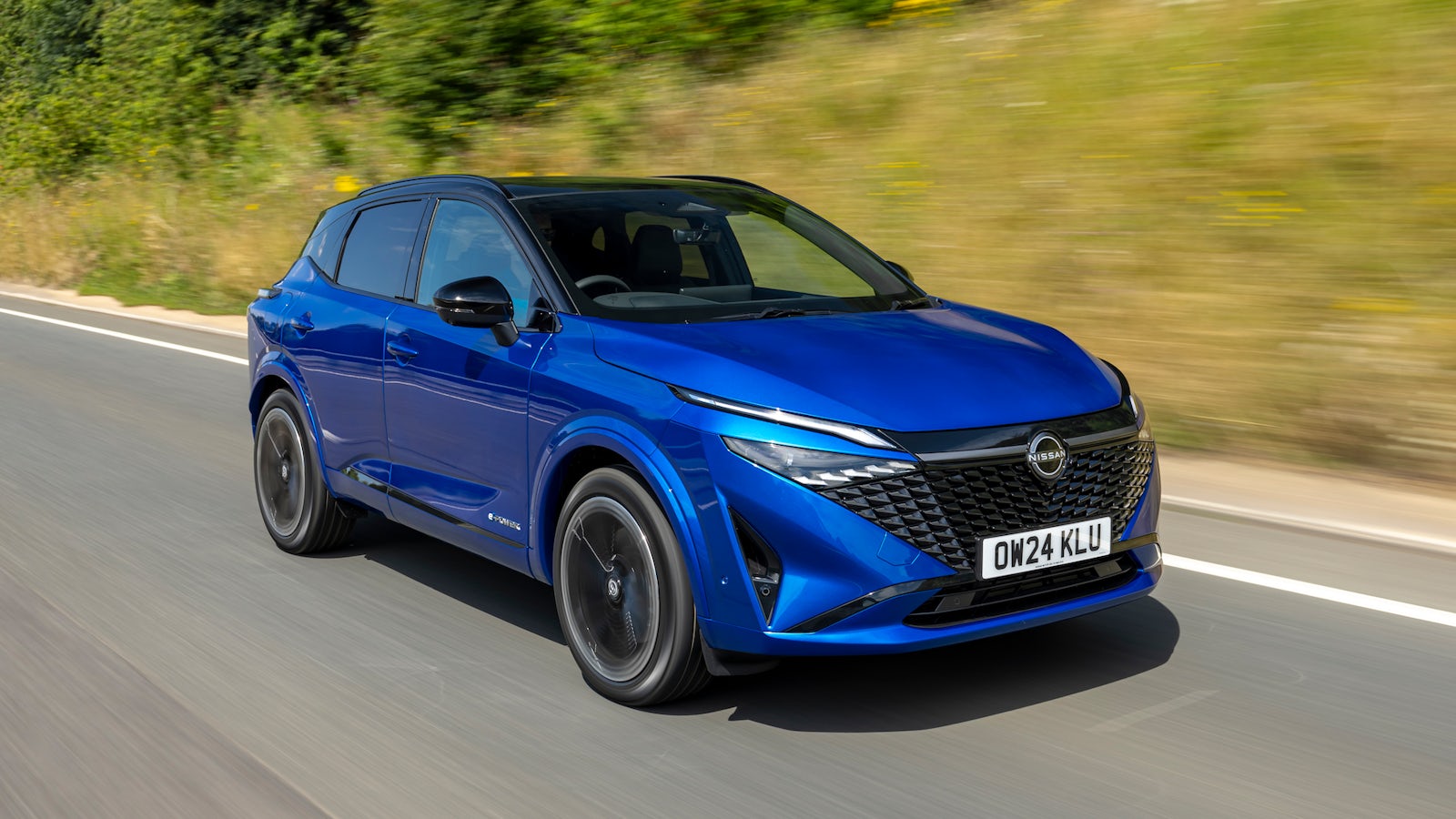 Blue Nissan Qashqai driving on road