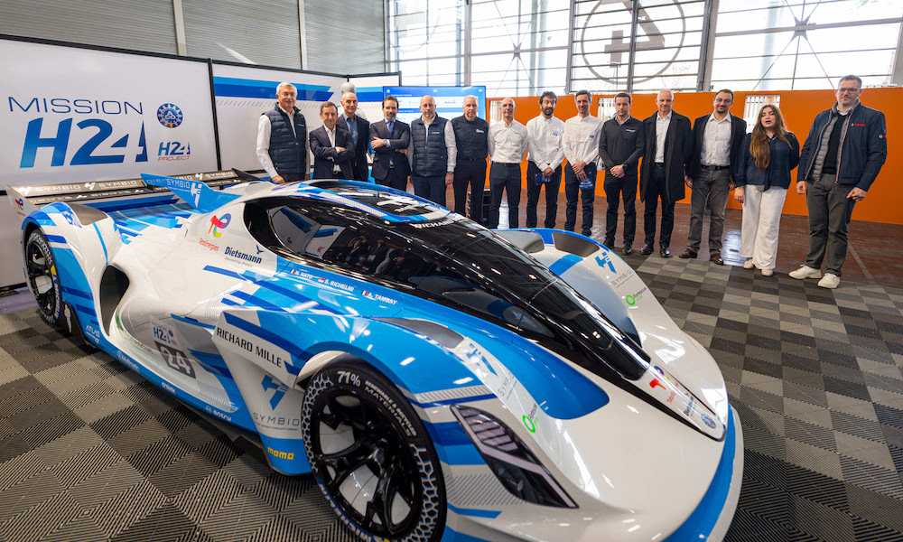 People standing by racing car