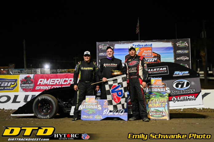 Three racers on victory podium