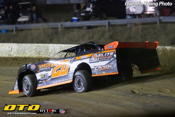 Race car speeds on dirt track