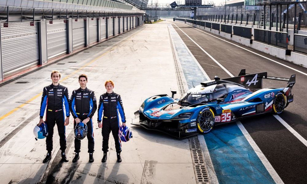 Three men beside Alpine race car