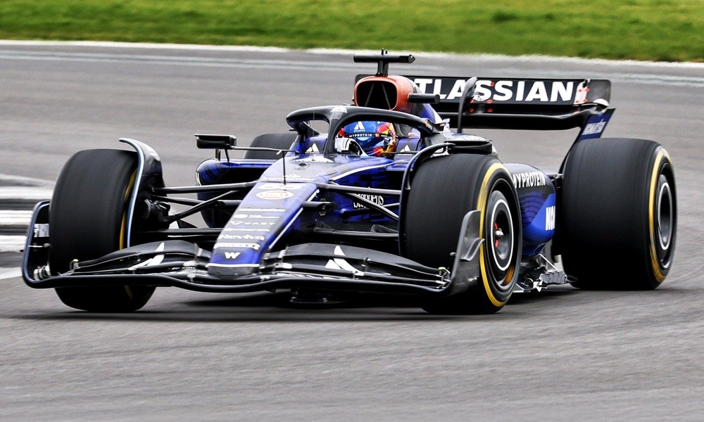 Indy car races on speedway track