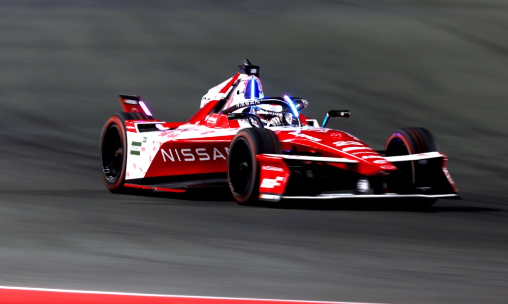 Red Nissan race car on track