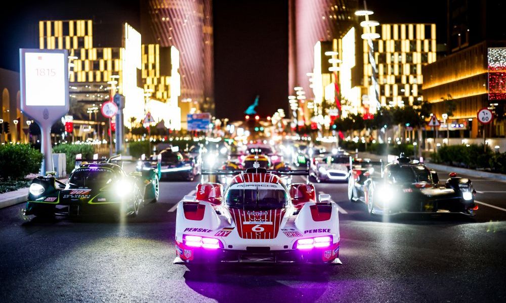 Formula E cars racing through cityscape