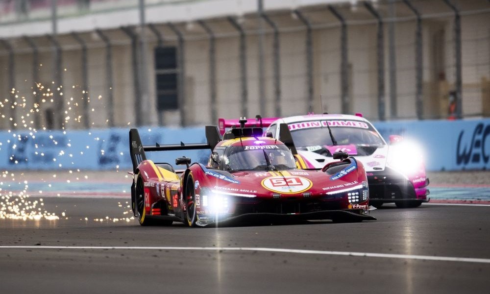 Red racecar speeding on circuit