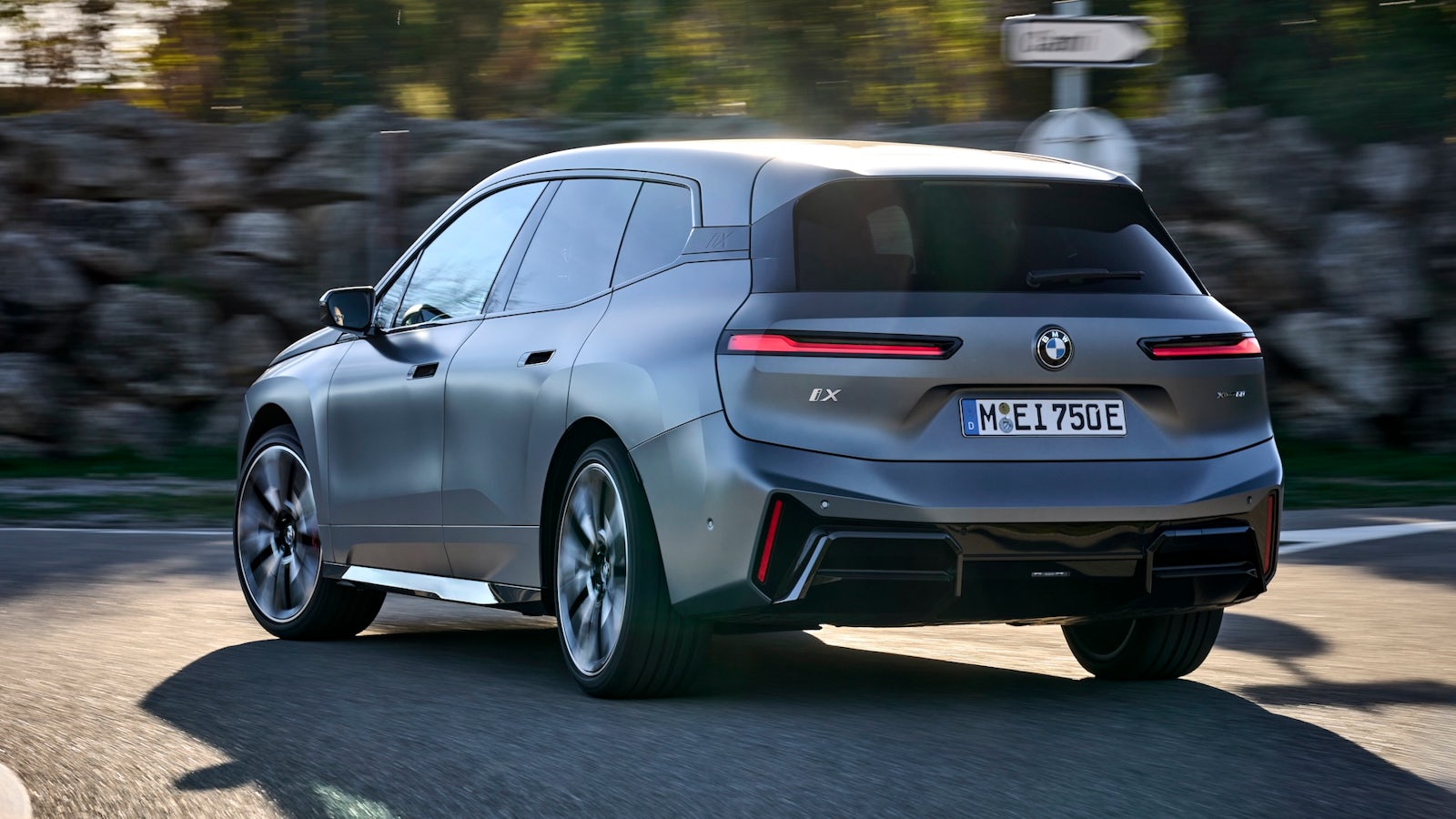 BMW iX driving, rear quarter view