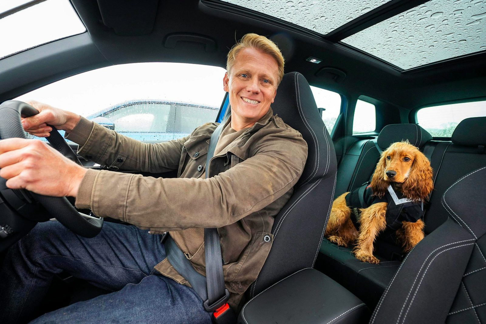 Man and dog in car