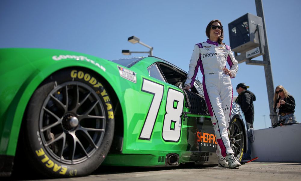 Race car driver crossing finish line